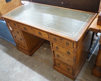 A Victorian light oak pedestal desk, fitted nine small drawers, width 120cm, depth 59cm, height 72cm